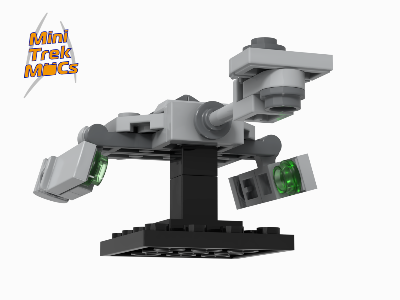 Low-angle view of a grey micro LEGO spaceship on a black stand, featuring wings with translucent green circular vents.