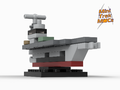Low-angle side view of a micro LEGO aircraft carrier model with a gray flight deck, red hull, and dark bridge tower.